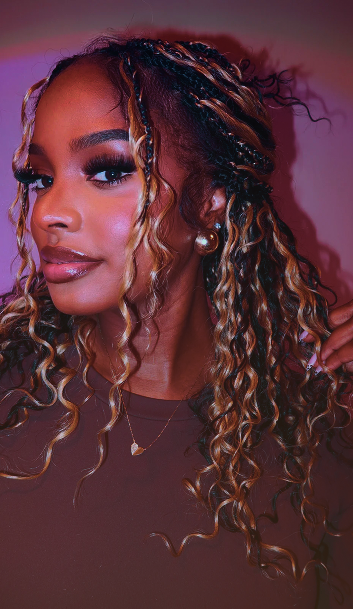 Woman with curly highlighted hair and braids